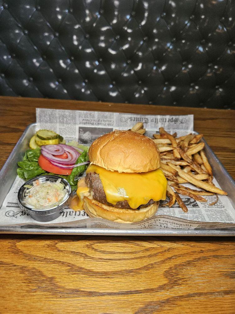 Classic cheeseburger with fries, coleslaw, pickles and fresh vegetables