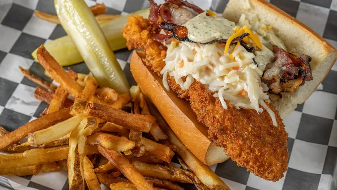 Crispy chicken sandwich with slaw, bacon and cheddar served with fries and pickles